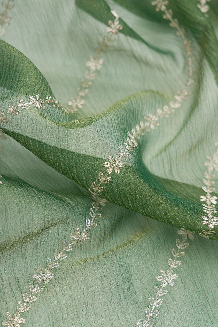Green Organza Silk Saree with Embroidery on the body and Embroidery Border. Includes unstitched blouse.